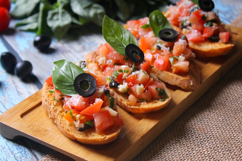 Bruschetta al Pomodoro with fresh tomatoes and basil on toasted bread